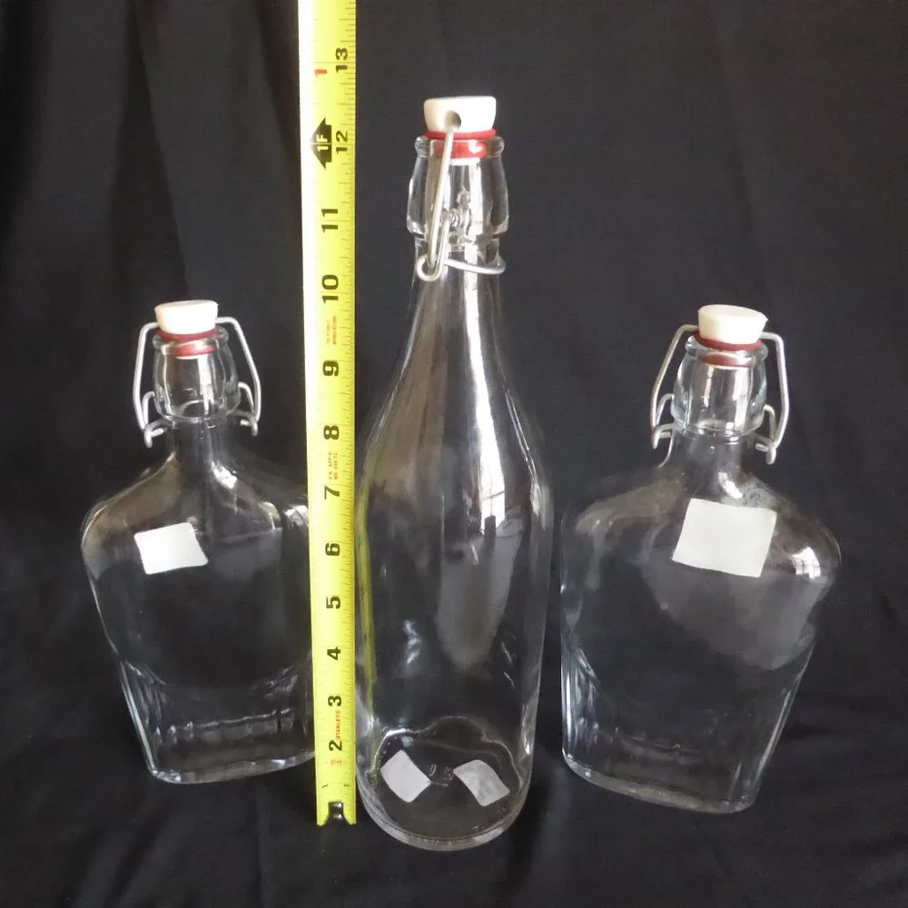 NEW 12.5” - 9.5” CRATE BARREL ITALY CLEAR GLASS AIR TIGHT LOCKING TOP 3 BOTTLES